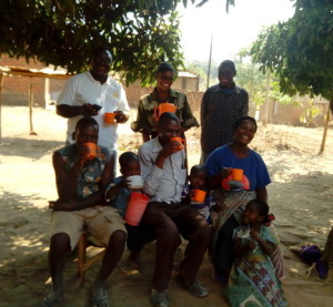     Researcher enjoying Thobwa La Zondeni drink with children and others