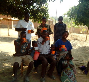 Researcher enjoying Thobwa La Zondeni drink with children and others