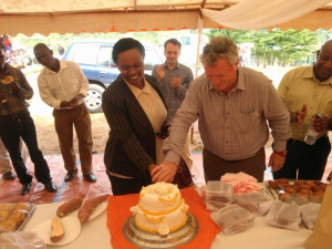 EU Ambassador and the Gakenke Vice Mayor cut a celebration sweetpotato cake during their visit to the SUSTAIN project processing unit in the district