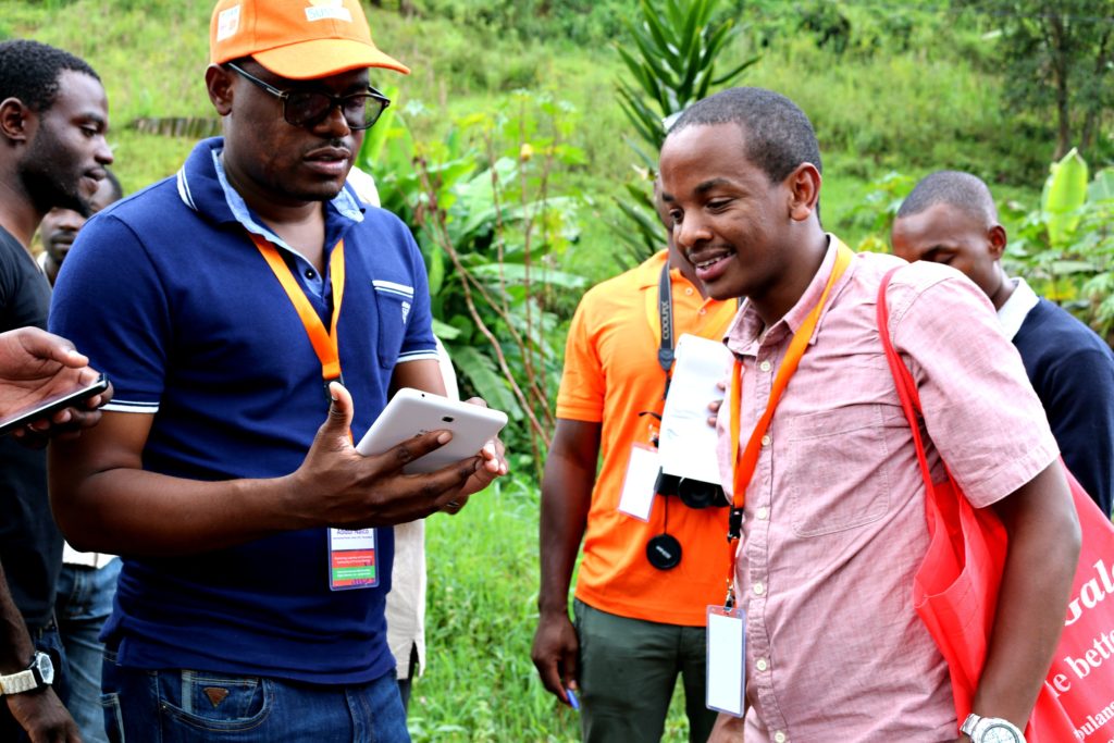 Luka Wanjohi (right) explains to MLE CoP members how one of the ODK forms works (C. Bukania)