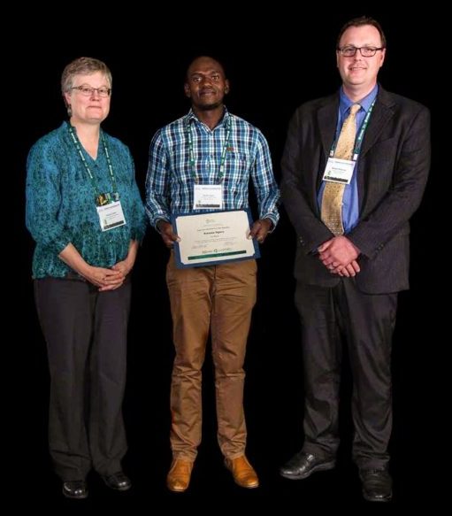Kwame Ogero (center) with the judges of the poster session