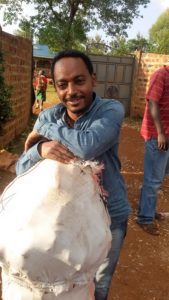 Temesgen Bocher with a sack full of sweetpotato