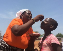 A Farmer feeding Vitamin A rich OFSP to her child (Credits: S. Rajendran )