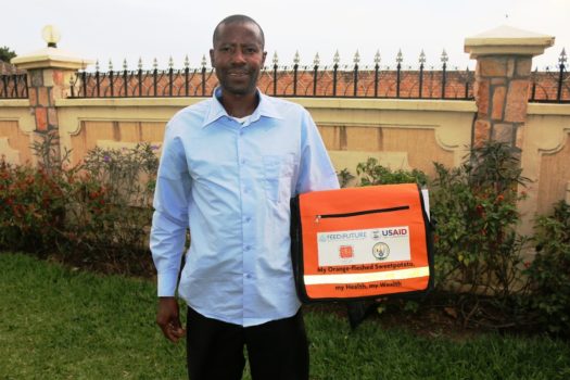 Mr Faustin showing off, a nutrition counselling kit after being trained by CIP