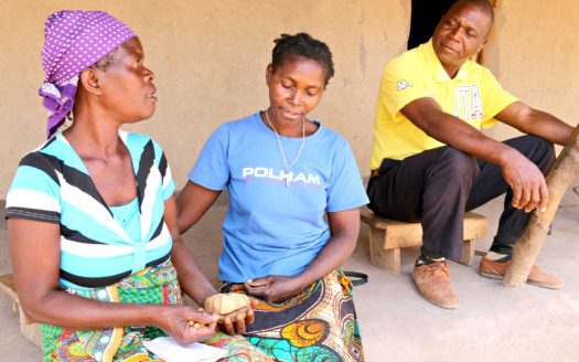 Teresa Abel, a nutrition counsellor in Mapudje, Mozambique, teaches Rosalina Armando