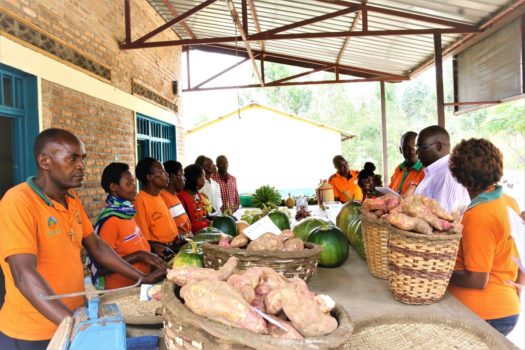 Cooperative members selling fresh fruits and vegetables at the roadside market (Photo by Aime Ndayisenga)